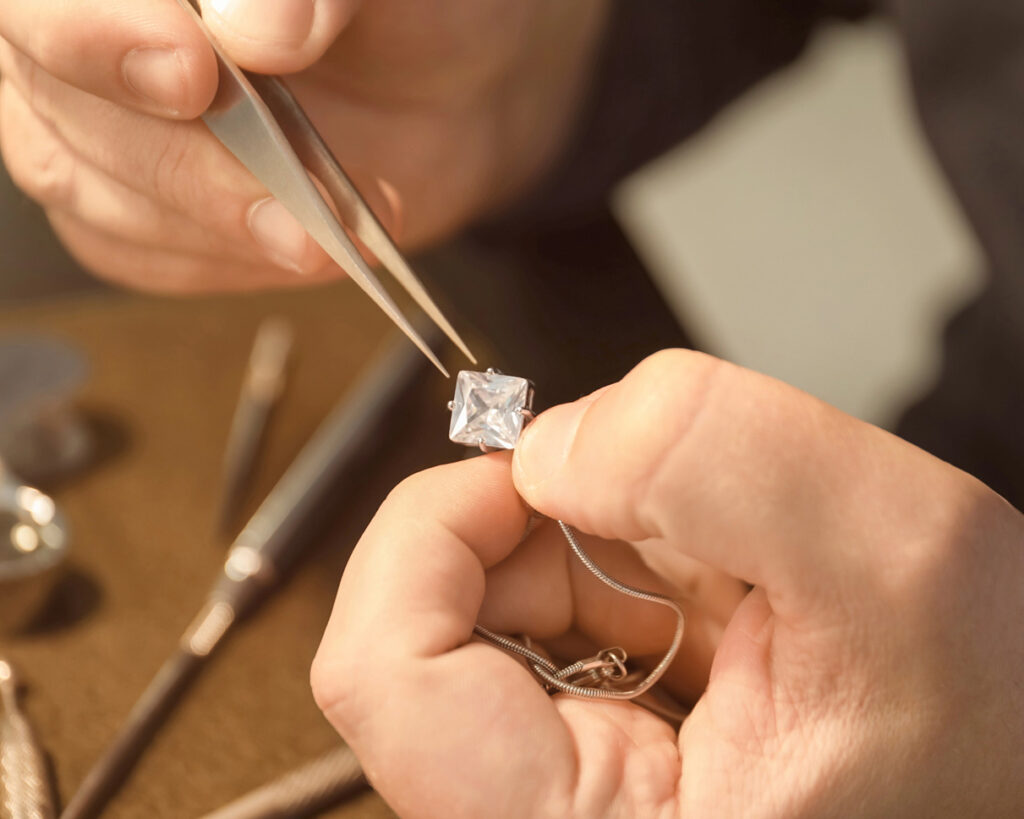 a skilled craftsperson repairing a necklace